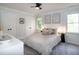 Bright bedroom with neutral tones, ceiling fan, and natural light from the windows at 3317 E Jameson Rd, Raleigh, NC 27604