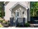A home's side entry shows an updated door, stairs, landscaping and paint at 3317 E Jameson Rd, Raleigh, NC 27604