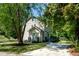 Charming two-story home featuring tan siding, updated landscaping and a mature, shady yard at 3317 E Jameson Rd, Raleigh, NC 27604