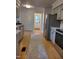 Spacious kitchen with stainless steel appliances, white subway tile, and hardwood flooring at 3317 E Jameson Rd, Raleigh, NC 27604