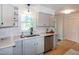 Updated kitchen featuring stainless steel appliances, white cabinets, and ample counter space at 3317 E Jameson Rd, Raleigh, NC 27604