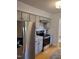 Stainless steel refrigerator and stove appliances with white subway tile backsplash and gray cabinetry at 3317 E Jameson Rd, Raleigh, NC 27604