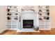 Close-up of the white brick fireplace with built in shelves on each side at 3317 E Jameson Rd, Raleigh, NC 27604