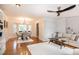 Bright, open-concept living room features hardwood floors and a modern ceiling fan at 3317 E Jameson Rd, Raleigh, NC 27604