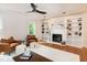 Bright and airy living room with a fireplace, built-in shelving, and hardwood floors throughout at 3317 E Jameson Rd, Raleigh, NC 27604