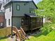 View of the back exterior, deck, and screened-in porch at 337 Merrywood Dr, Raleigh, NC 27610