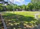 Community baseball field with well-kept grass and a tree-lined perimeter at 337 Merrywood Dr, Raleigh, NC 27610