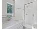 Bathroom featuring a glass shower, a white vanity, and a window with natural light at 337 Merrywood Dr, Raleigh, NC 27610