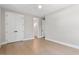 Well-appointed bedroom with light hardwood floors, bright walls, ceiling fan, and access to a bathroom at 337 Merrywood Dr, Raleigh, NC 27610