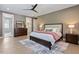 Bright bedroom boasts hardwood floors, a ceiling fan, neutral walls, and tasteful furnishings and decor at 337 Merrywood Dr, Raleigh, NC 27610