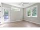 Bedroom with a door to the deck, two windows, and hardwood flooring at 337 Merrywood Dr, Raleigh, NC 27610
