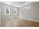 Well-lit bedroom with hardwood floors, ceiling fan, and large windows providing ample natural light at 337 Merrywood Dr, Raleigh, NC 27610