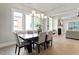 Bright dining room with a modern chandelier, a dark wood table, and neutral decor at 337 Merrywood Dr, Raleigh, NC 27610