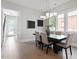 Bright dining room with a modern chandelier, a dark wood table, and neutral decor at 337 Merrywood Dr, Raleigh, NC 27610