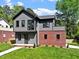 Charming two-story home with gray siding, a red brick accent, and a well-manicured lawn at 337 Merrywood Dr, Raleigh, NC 27610