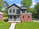 Charming two-story home with gray siding, a red brick accent, and a well-manicured lawn at 337 Merrywood Dr, Raleigh, NC 27610