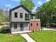 Charming two-story home with gray siding, a red brick accent, and a well-manicured lawn at 337 Merrywood Dr, Raleigh, NC 27610