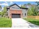Beautiful two-story home featuring a brick garage and well-manicured lawn at 337 Merrywood Dr, Raleigh, NC 27610