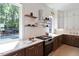 Gourmet kitchen featuring stainless appliances, open shelves and custom cabinets at 337 Merrywood Dr, Raleigh, NC 27610
