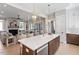 Open concept living room with kitchen island and stainless steel dishwasher at 337 Merrywood Dr, Raleigh, NC 27610