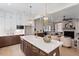 Open concept kitchen and living room space with modern island and fireplace at 337 Merrywood Dr, Raleigh, NC 27610