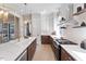 Open kitchen with modern island, gas cooktop, and pendant lights at 337 Merrywood Dr, Raleigh, NC 27610