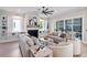 Bright living room with a fireplace, built-in shelves and a ceiling fan at 337 Merrywood Dr, Raleigh, NC 27610