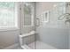 Glass-enclosed shower stall featuring white subway tiles and a built-in bench for comfort and convenience at 337 Merrywood Dr, Raleigh, NC 27610