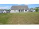 Back exterior of the home with a large, well-maintained lawn at 367 Fenella Dr, Four Oaks, NC 27524