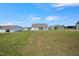Expansive backyard with ample green space and a view of the home's exterior at 367 Fenella Dr, Four Oaks, NC 27524