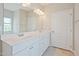 Bright bathroom featuring a double sink vanity with white cabinets and a large mirror at 367 Fenella Dr, Four Oaks, NC 27524