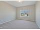 Bright bedroom features neutral carpet and walls, and a window providing natural light at 367 Fenella Dr, Four Oaks, NC 27524
