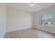 Bright, empty bedroom features wood floors and a large window with natural light at 367 Fenella Dr, Four Oaks, NC 27524
