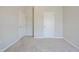 The hallway has neutral carpet and paint with a door on either side at 367 Fenella Dr, Four Oaks, NC 27524