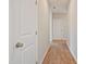 Hallway featuring wood-look flooring, white doors and neutral walls at 367 Fenella Dr, Four Oaks, NC 27524