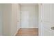 Hallway showing multiple white doors and laminate flooring at 367 Fenella Dr, Four Oaks, NC 27524