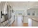 Open kitchen with stainless steel appliances, white cabinets, and granite countertops at 367 Fenella Dr, Four Oaks, NC 27524