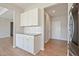 Kitchen showcasing white cabinets, granite countertops, and stainless steel refrigerator at 367 Fenella Dr, Four Oaks, NC 27524