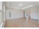 Spacious living room with tray ceiling, wood floors, and abundant natural light at 367 Fenella Dr, Four Oaks, NC 27524