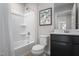 A well-lit bathroom features a bathtub with shower and a modern toilet, complemented by stylish fixtures and decor at 368 N Coral Bells Way, Four Oaks, NC 27524