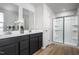 Modern bathroom boasts a double vanity with sleek countertops and a glass-enclosed shower, offering a clean and functional design at 368 N Coral Bells Way, Four Oaks, NC 27524