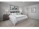 Bright bedroom featuring a bed with soft white linens and decorative pillows, creating a comfortable and inviting space at 368 N Coral Bells Way, Four Oaks, NC 27524
