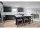 Bright kitchen boasts black cabinets, a white countertop island, and seamless access to the dining area at 368 N Coral Bells Way, Four Oaks, NC 27524