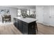 Kitchen island with white countertops opens to dining and living area for entertaining and daily living at 368 N Coral Bells Way, Four Oaks, NC 27524