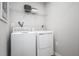 Bright laundry room features a white washer and dryer set and white wire shelving at 368 N Coral Bells Way, Four Oaks, NC 27524