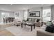 Open-concept living area featuring a dining set and comfortable seating arrangement with natural light at 368 N Coral Bells Way, Four Oaks, NC 27524