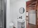 Modern bathroom with sleek fixtures and a stylish round mirror and sink at 3806 Sue Ln, Raleigh, NC 27604