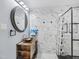 Modern bathroom featuring stylish wood vanity and a frameless glass shower with marble tile at 3806 Sue Ln, Raleigh, NC 27604
