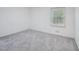 Bright bedroom featuring neutral carpet, a window, and ample space at 3806 Sue Ln, Raleigh, NC 27604