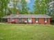 Charming single-story brick home with lush front lawn and colorful landscaping at 3806 Sue Ln, Raleigh, NC 27604